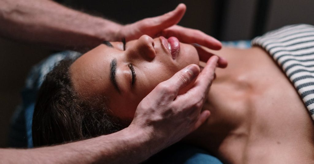 Close-up of a woman receiving a soothing facial massage in a serene spa environment.